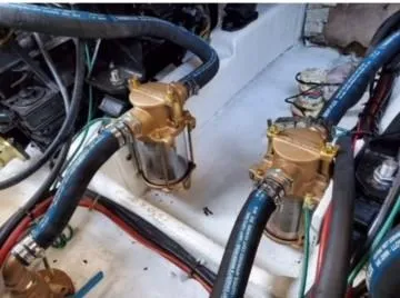 Slide: The Image of Engine compartment of a 1992 Bayliner 3288 with dual brass pumps and hoses. - 25