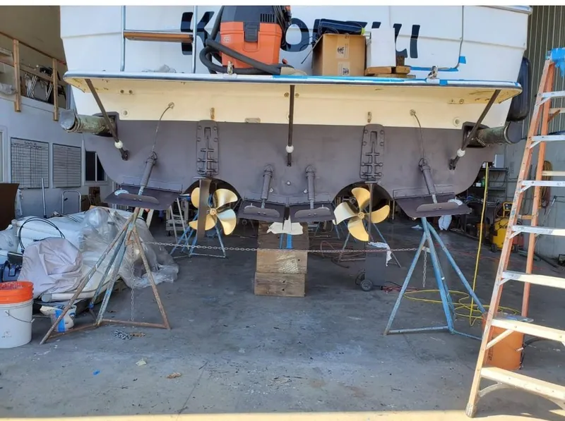 Slide: The Image of 1992 Bayliner 3288 boat in dry dock, showing dual propellers and maintenance equipment. - 27