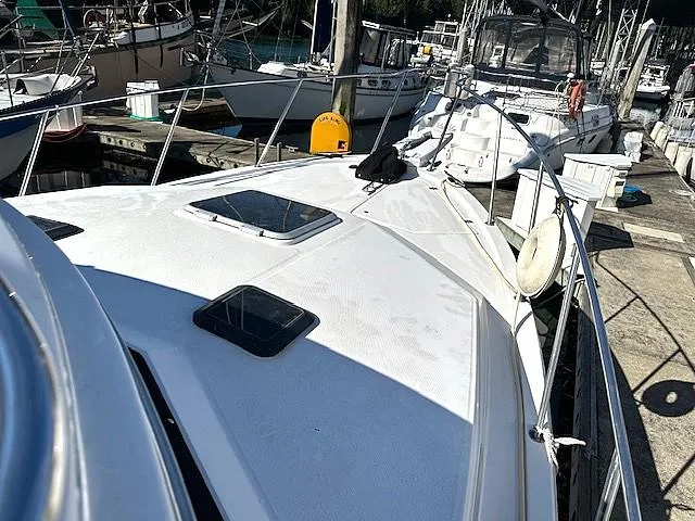 Slide: The Image of 1992 Bayliner 3288 boat docked at marina, featuring spacious deck and sleek design. - 28