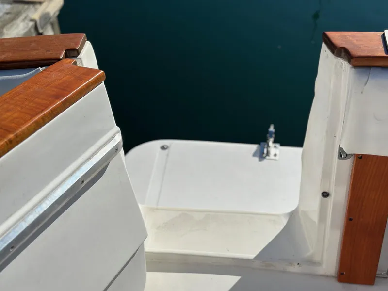 Slide: The Image of 1992 Bayliner 3288 boat deck with wooden trim and water view. - 4