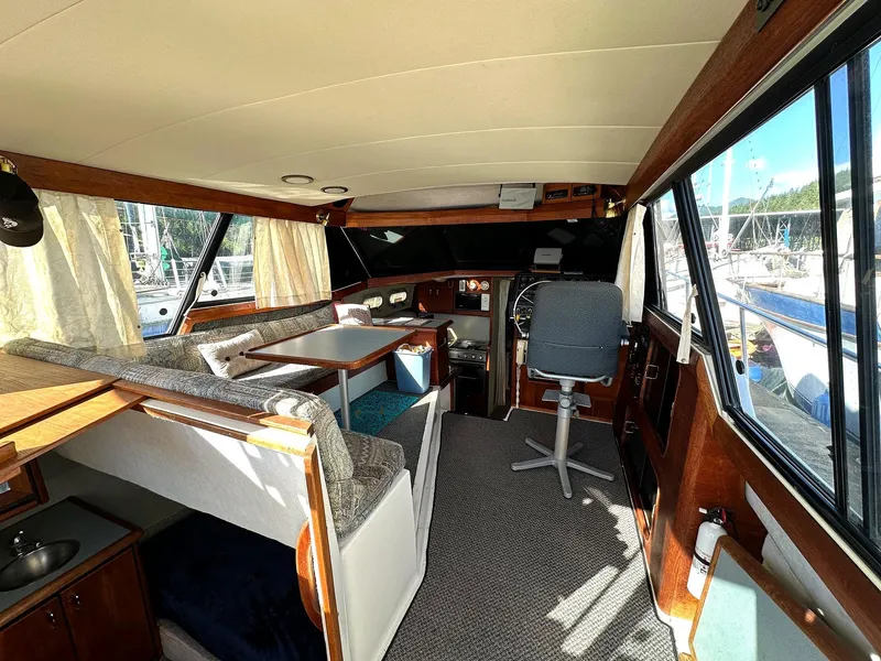 Slide: The Image of Interior of a 1992 Bayliner 3288 boat with seating, table, and helm station. - 6