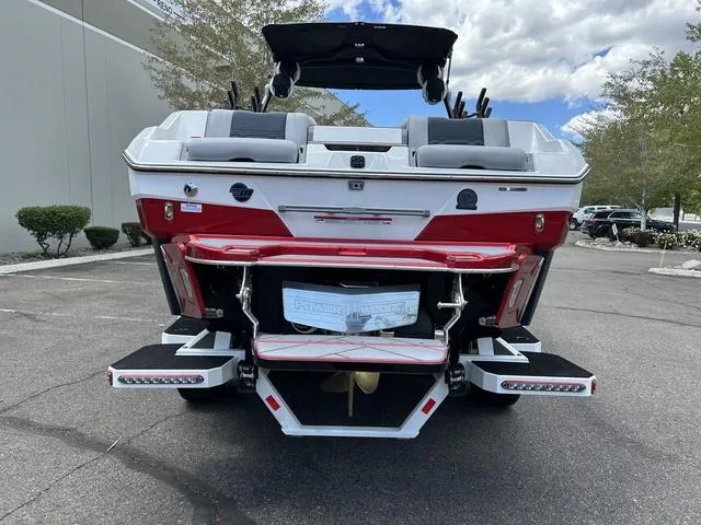 Slide: The Image of 2024 Malibu 25 LSV boat, rear view, parked outdoors. - 3