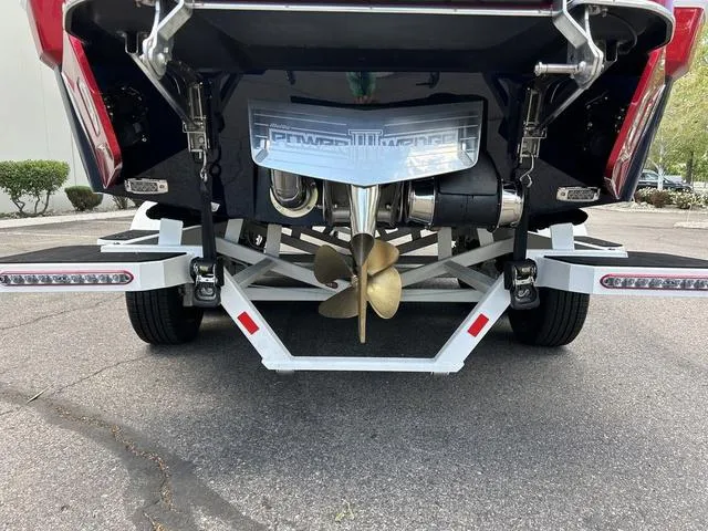 Slide: The Image of 2024 Malibu 25 LSV boat rear view showing propeller and trailer. - 4