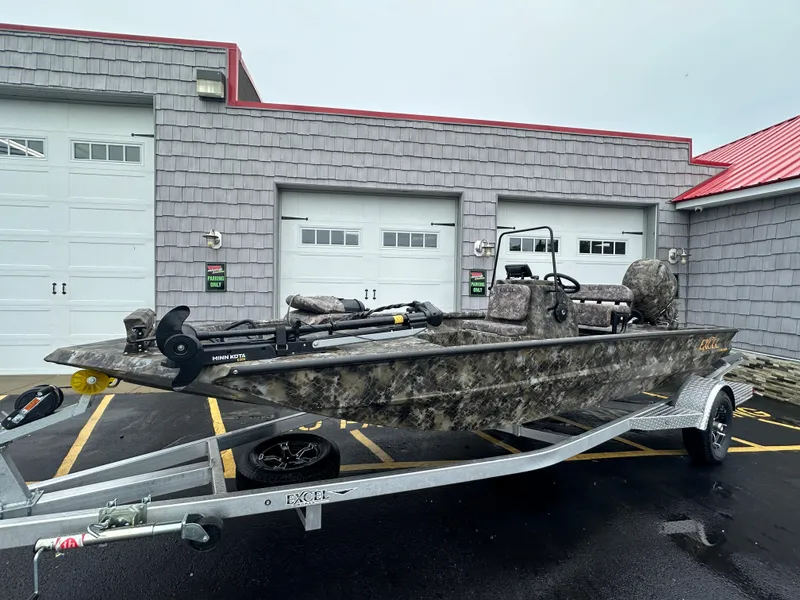 Slide: The Image of 2025 Excel 1960 Stalker CC boat on trailer in front of garage. - 0