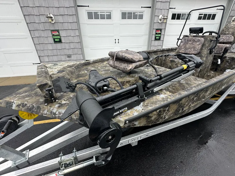 Slide: The Image of 2025 Excel 1960 Stalker CC boat with camouflage design on trailer. - 11