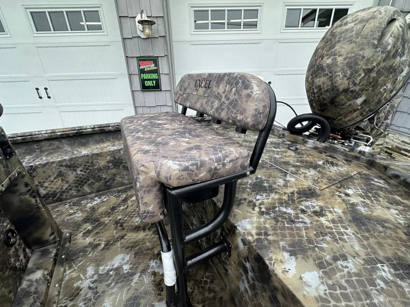 Slide: The Image of 2025 Excel 1960 Stalker CC boat with camo seating and accessories. - 18