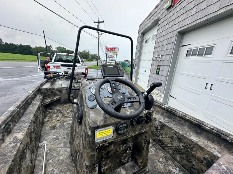 Slide: The Image of 2025 Excel 1960 Stalker CC boat console with steering wheel and controls. - 24