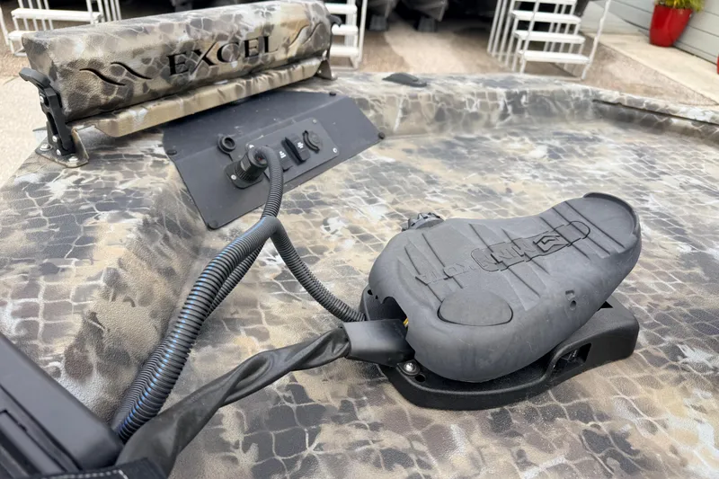 Slide: The Image of Camouflage-patterned deck of 2025 Excel 1960 Stalker CC boat with control panel. - 25