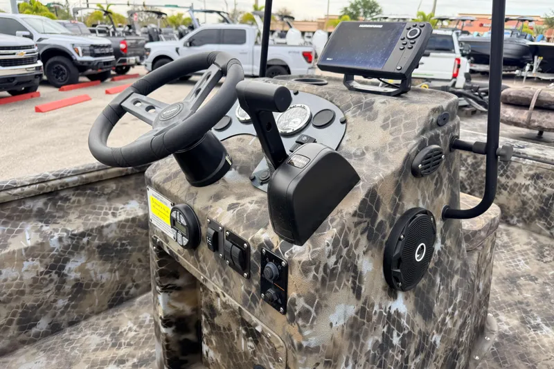 Slide: The Image of Control console of 2025 Excel 1960 Stalker CC boat with camo design and navigation equipment. - 27