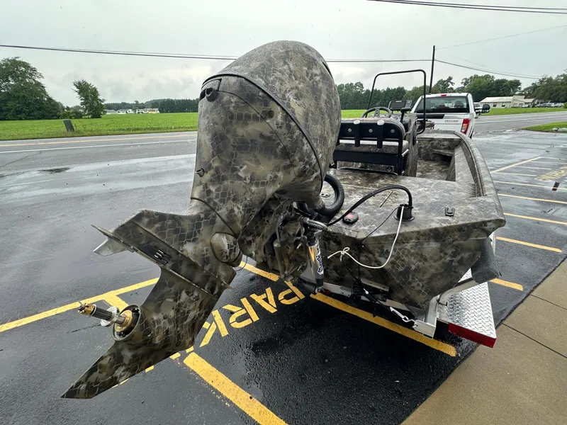 Slide: The Image of 2025 Excel 1960 Stalker CC boat with camo design on a trailer. - 29