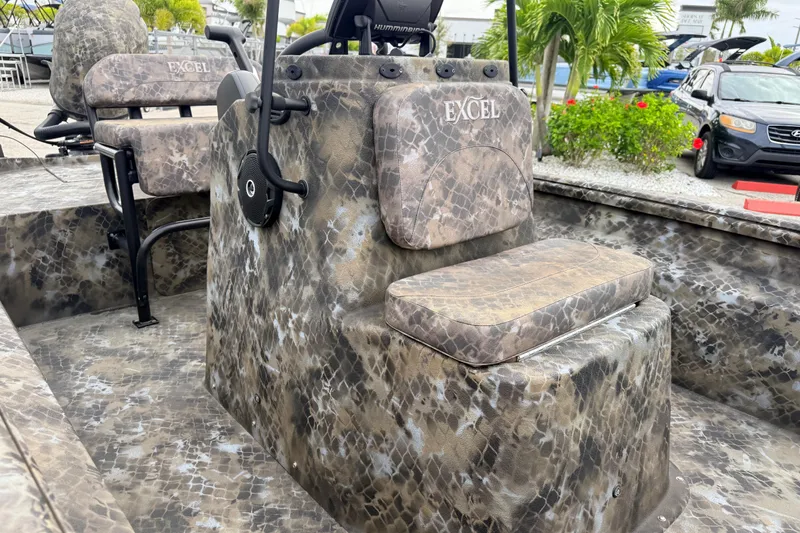 Slide: The Image of Camouflage-patterned 2025 Excel 1960 Stalker CC boat interior with seating and controls. - 39