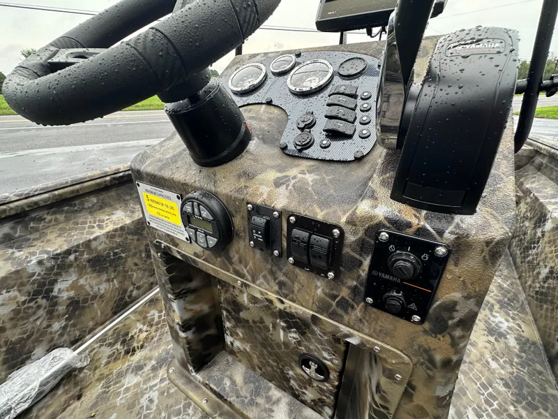 Slide: The Image of Control panel of 2025 Excel 1960 Stalker CC boat with steering wheel and gauges. - 9