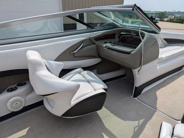 Slide: The Image of 2013 Crownline 21 SS boat interior with white seating and sleek dashboard design. - 11