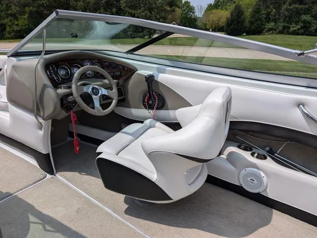 Slide: The Image of Interior of 2013 Crownline 21 SS boat with steering wheel and seating. - 12