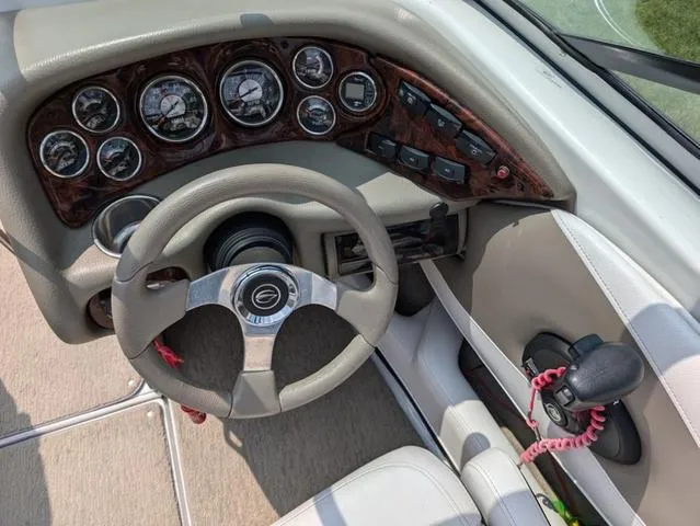 Slide: The Image of 2013 Crownline 21 SS boat dashboard with steering wheel and instrument panel. - 13