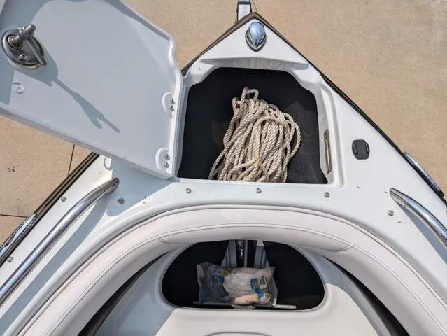 Slide: The Image of Open storage compartment on 2013 Crownline 21 SS boat with coiled rope. - 15