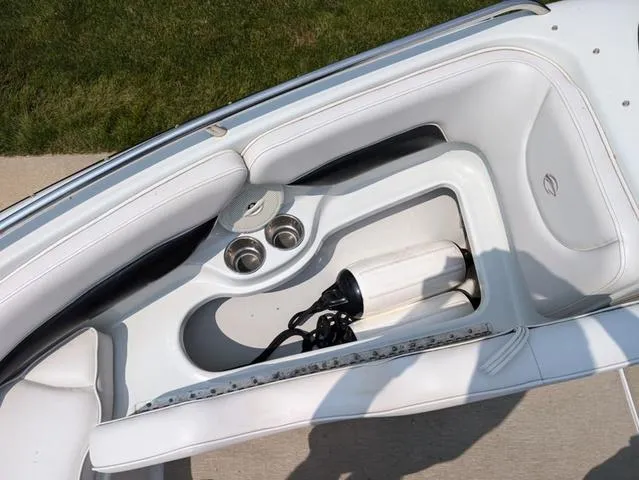 Slide: The Image of 2013 Crownline 21 SS boat interior with white seating and cup holders. - 16