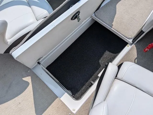 Slide: The Image of Open storage compartment in 2013 Crownline 21 SS boat interior. - 17