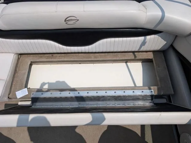 Slide: The Image of Crownline 21 SS 2013 boat interior storage compartment with white and black seating. - 18