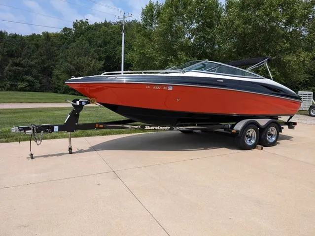 Slide: The Image of 2013 Crownline 21 SS boat on trailer, parked outdoors. - 5