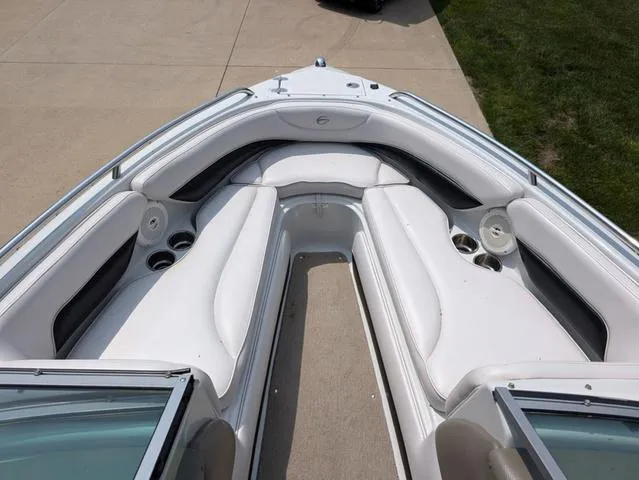 Slide: The Image of 2013 Crownline 21 SS boat interior with white seating and cup holders. - 9