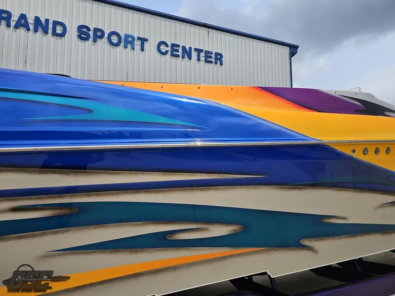 Slide: The Image of 2004 Outerlimits 42 Legacy boat with vibrant paint job at Grand Sport Center. - 10
