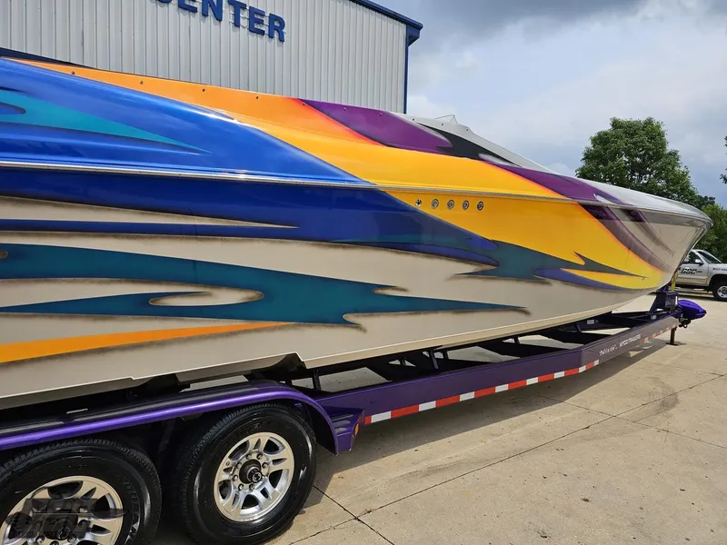 Slide: The Image of 2004 Outerlimits 42 Legacy speedboat with vibrant custom paint on trailer. - 11