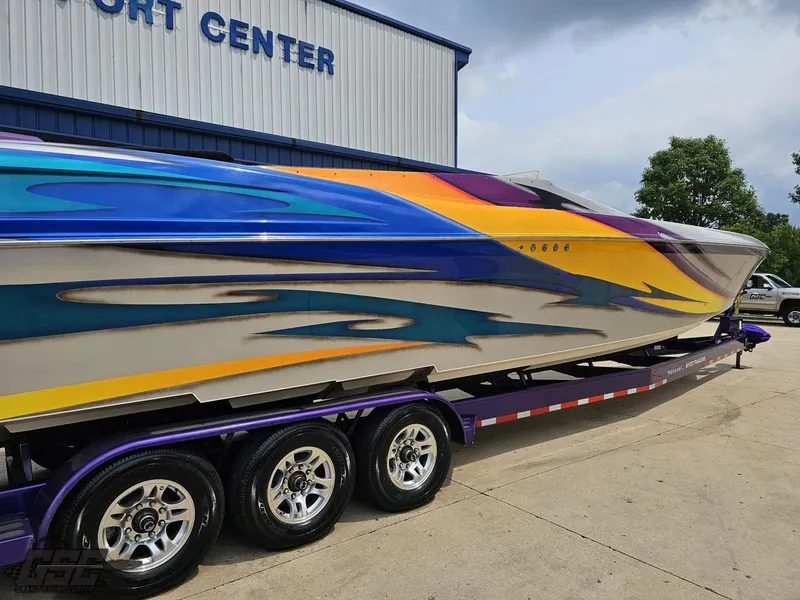 Slide: The Image of 2004 Outerlimits 42 Legacy speedboat with vibrant custom paint on a trailer. - 12
