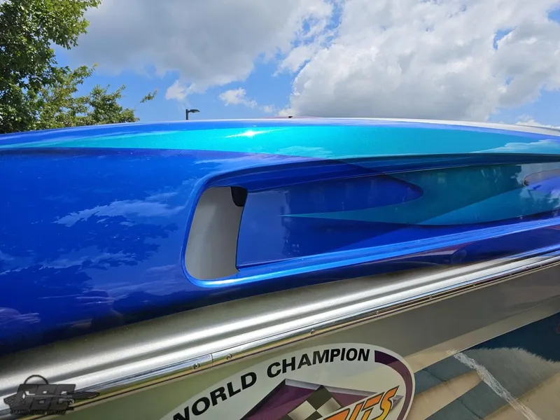 Slide: The Image of Close-up of a 2004 Outerlimits 42 Legacy boat with vibrant blue paint. - 18