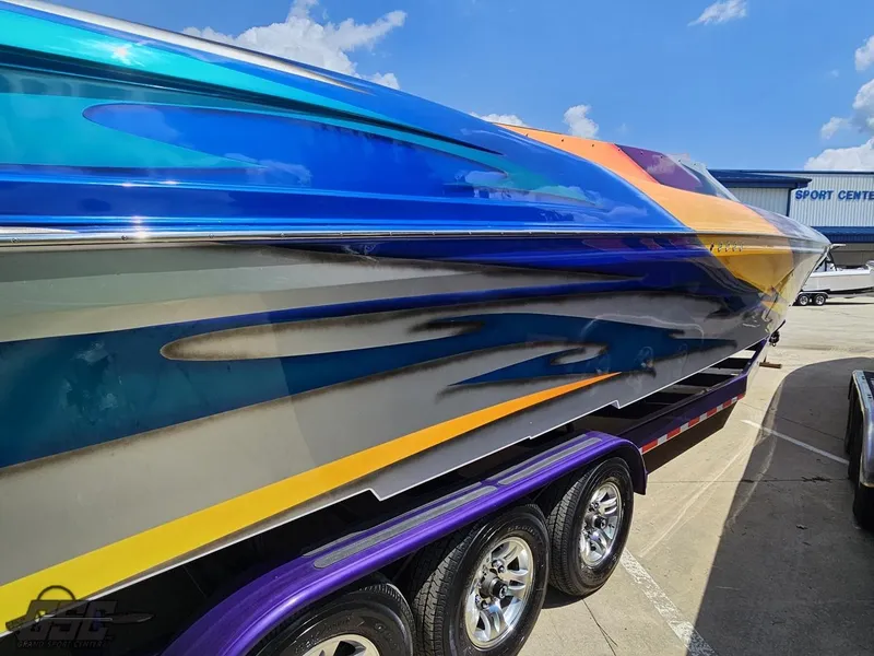 Slide: The Image of 2004 Outerlimits 42 Legacy speedboat with vibrant custom paint job on trailer. - 21