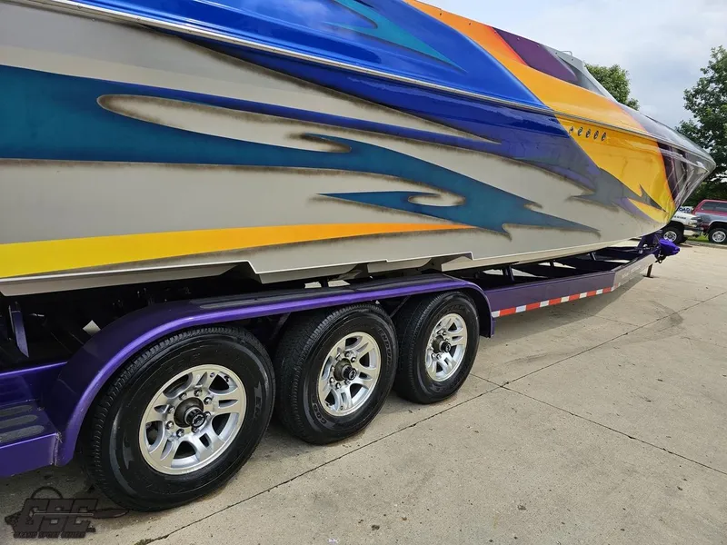 Slide: The Image of 2004 Outerlimits 42 Legacy boat on a trailer with vibrant graphics. - 22