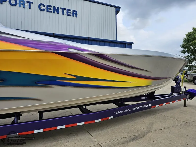 Slide: The Image of 2004 Outerlimits 42 Legacy speedboat on trailer with vibrant paint job. - 23