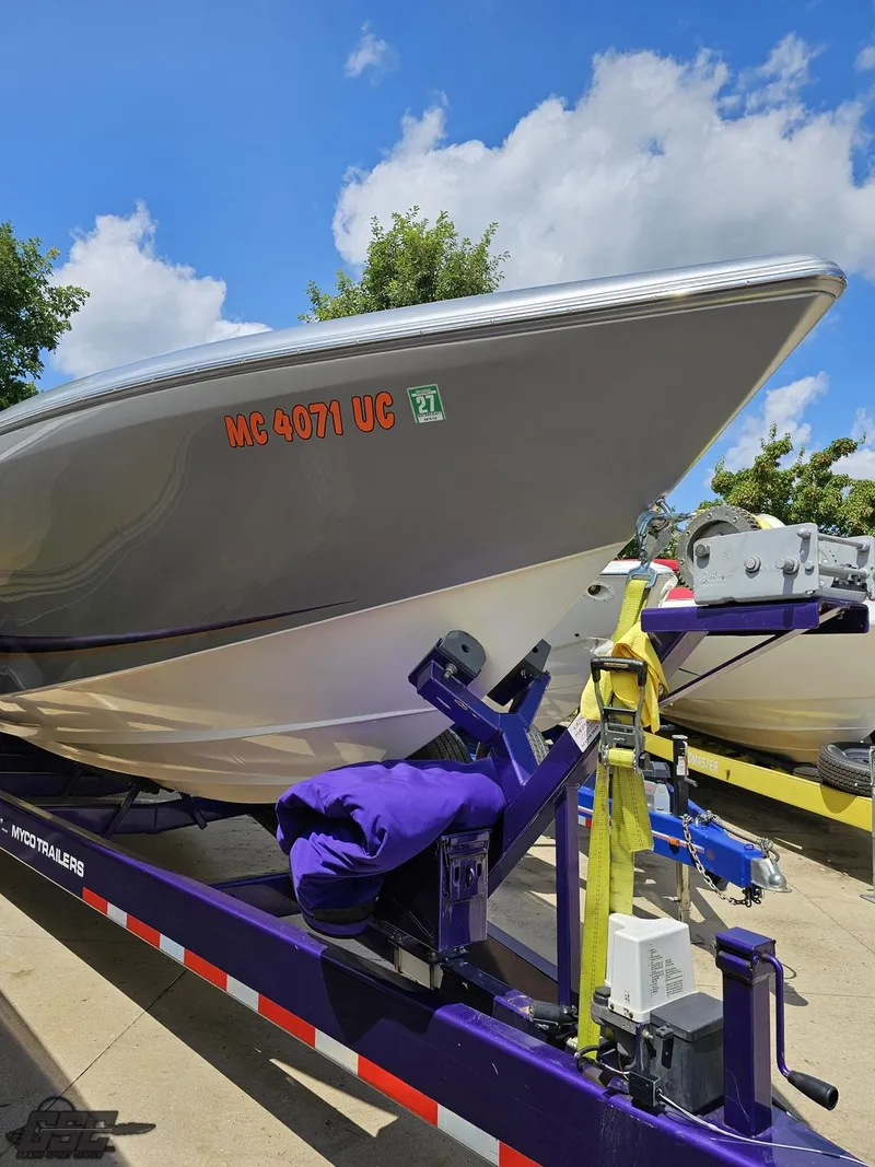 Slide: The Image of 2004 Outerlimits 42 Legacy boat on a trailer under a blue sky. - 27