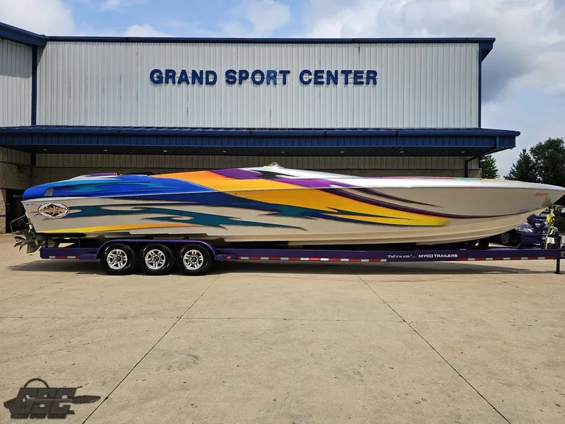 Slide: The Image of 2004 Outerlimits 42 Legacy speedboat with vibrant graphics at Grand Sport Center. - 3