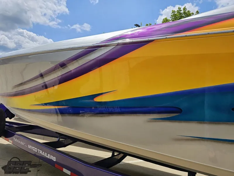 Slide: The Image of 2004 Outerlimits 42 Legacy boat with vibrant yellow, purple, and blue graphics. - 37