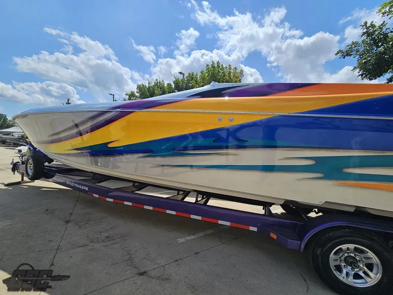Slide: The Image of 2004 Outerlimits 42 Legacy speedboat with vibrant custom paint on trailer. - 39
