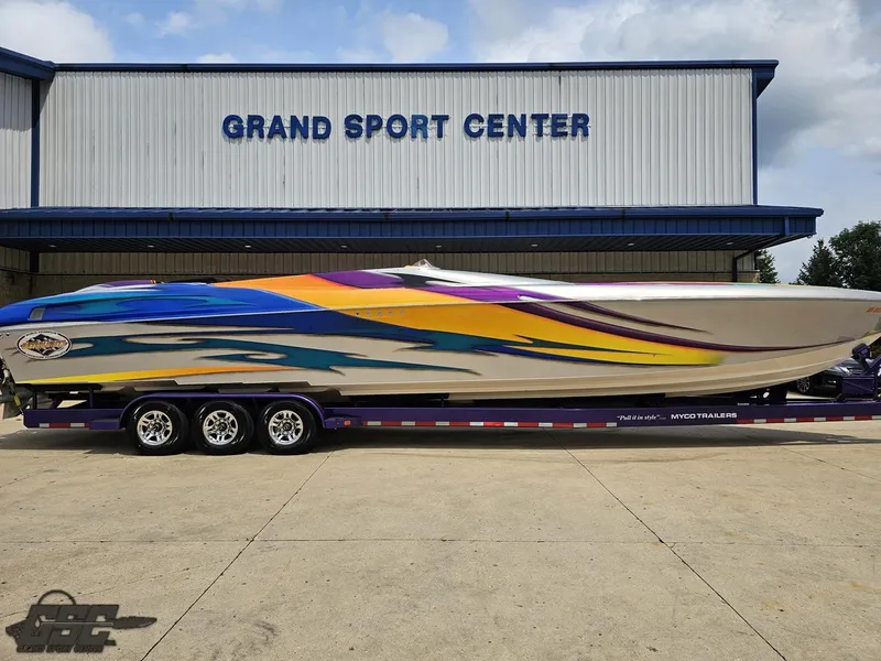 Slide: The Image of 2004 Outerlimits 42 Legacy speedboat with vibrant graphics at Grand Sport Center. - 4