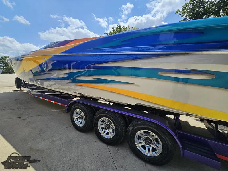 Slide: The Image of 2004 Outerlimits 42 Legacy speedboat on a trailer with vibrant custom paint. - 41