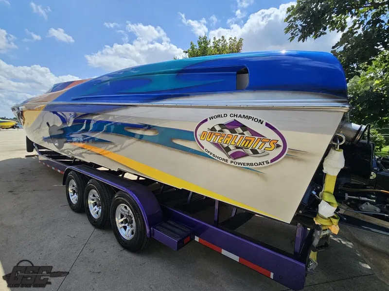 Slide: The Image of 2004 Outerlimits 42 Legacy powerboat on a trailer under a sunny sky. - 42
