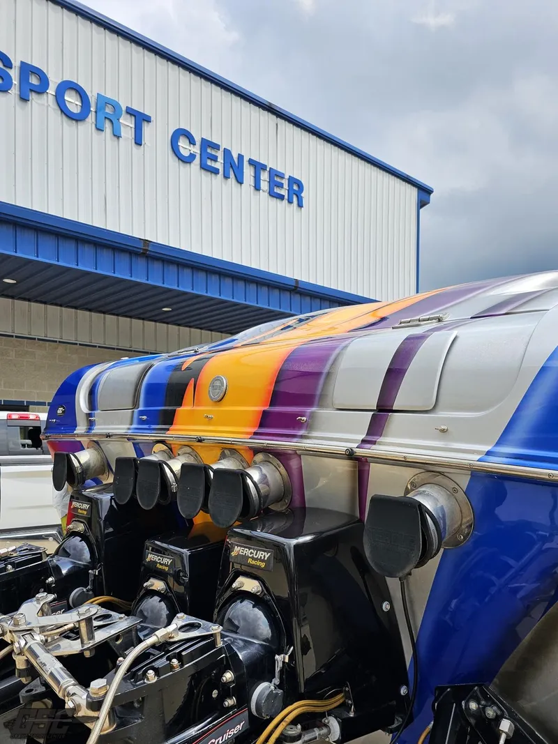Slide: The Image of 2004 Outerlimits 42 Legacy boat at a sport center with vibrant paint job. - 49