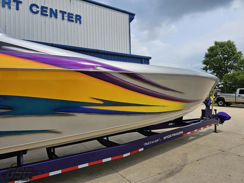 Slide: The Image of 2004 Outerlimits 42 Legacy speedboat with vibrant graphics on a trailer. - 7