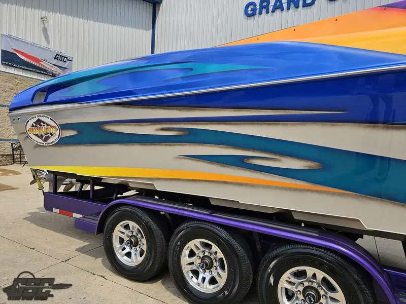 Slide: The Image of 2004 Outerlimits 42 Legacy speedboat with vibrant custom paint job on trailer. - 9