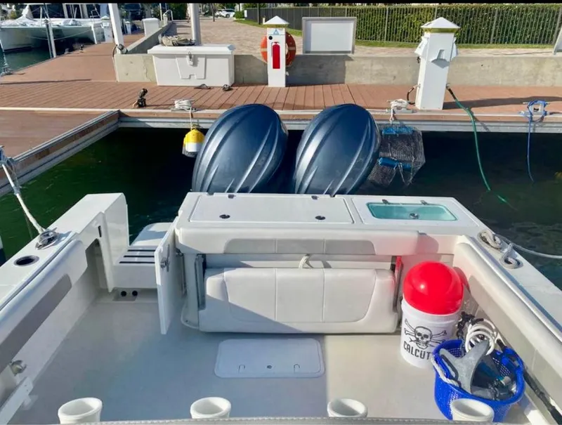 Slide: The Image of 2022 Parker 2801 Center Console boat docked at marina with twin outboard engines. - 10