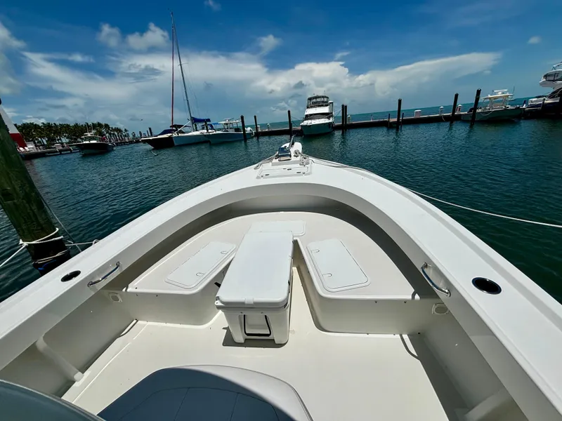 Slide: The Image of 2022 Parker 2801 Center Console boat docked at a marina on a sunny day. - 4