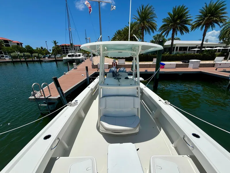 Slide: The Image of 2022 Parker 2801 Center Console boat docked at a marina with palm trees. - 5