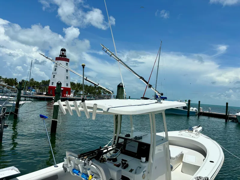 Slide: The Image of 2022 Parker 2801 Center Console boat docked near a lighthouse on a sunny day. - 7