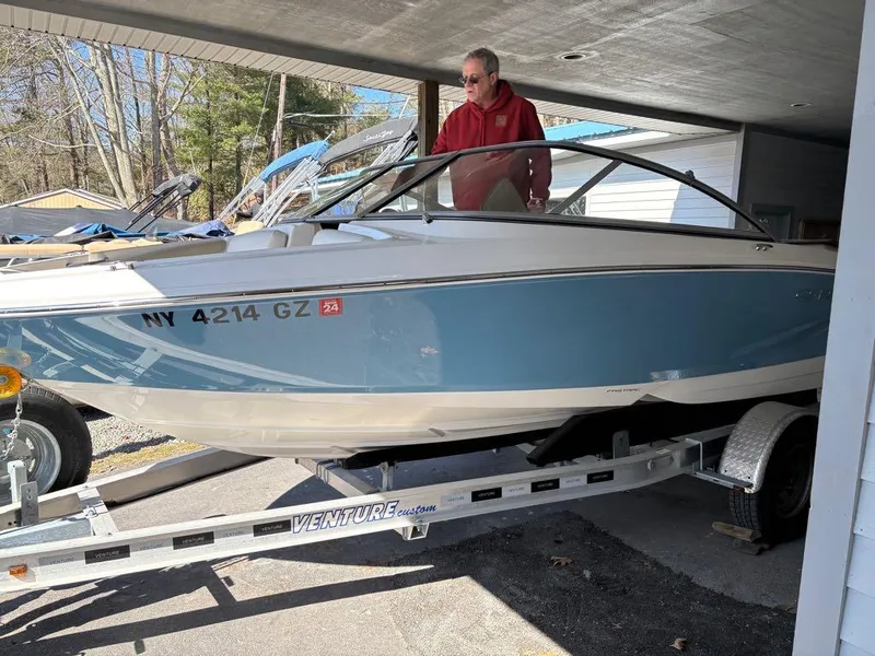 Slide: The Image of 2017 Regal 1900 ES boat on trailer, parked under a shelter. - 12