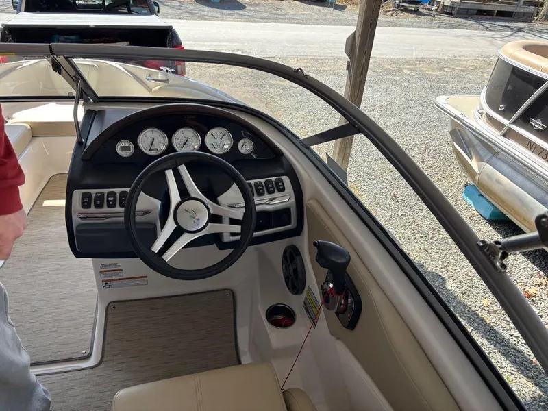 Slide: The Image of 2017 Regal 1900 ES boat dashboard with steering wheel and gauges. - 4