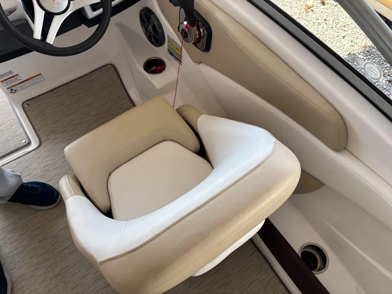 Slide: The Image of 2017 Regal 1900 ES boat interior with beige captain's seat and steering wheel. - 6