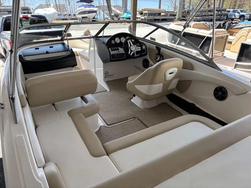 Slide: The Image of 2017 Regal 1900 ES boat interior with beige seating and steering console. - 7